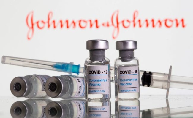 FILE PHOTO: Vials labeled “COVID-19 Coronavirus Vaccine” and syringe are seen in front of displayed J&J logo in this illustration